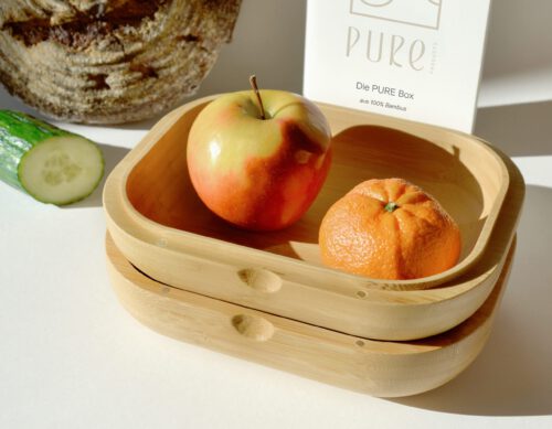 box mit mandarine und apfel